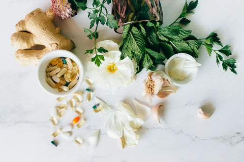 VivoNu natural dietary supplements surrounded by fresh herbal ingredients and organic root extracts